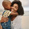 Son kissing mother on the beach