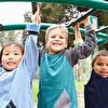 Three boys hanging on the playground