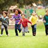 Children competiting in running on grass