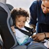 Baby girl sitting in a child seat and mother laughing