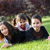 Kids lying on the grass and smiling