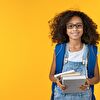 Student girl hold books in her hand and smiling