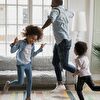 Father and children dancing in the living room