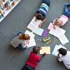 children lying on floor and studying