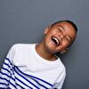 boy laughing with eyes closed
