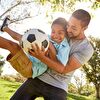Father and Son Having Fun Together With Soccer Ball