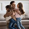 Father Hugging Two Daughters