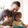 Father With Kids Reading Storybook