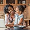 Mother With Laptop Hugging Daughter