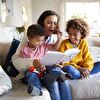 Mother With Two Kids Enjoying Reading Storybook